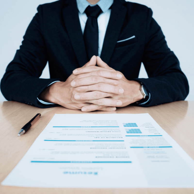 Photo of person sitting at desk with resume